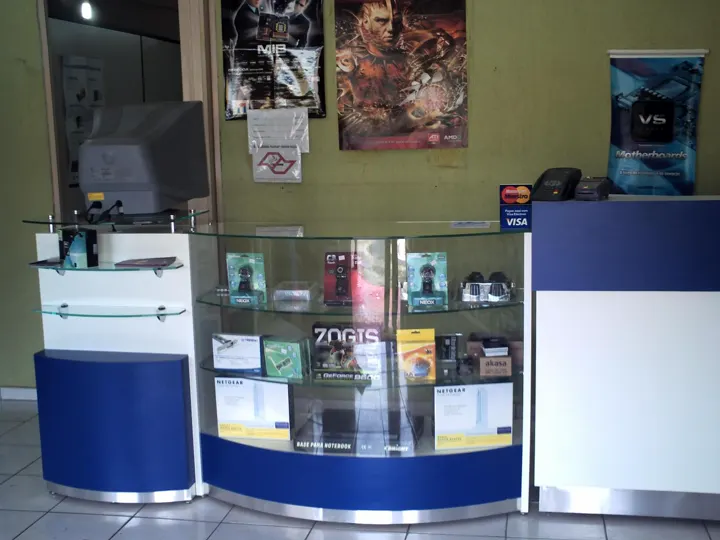 Balcão de vidro da loja com webcams, placas de rede e routers
